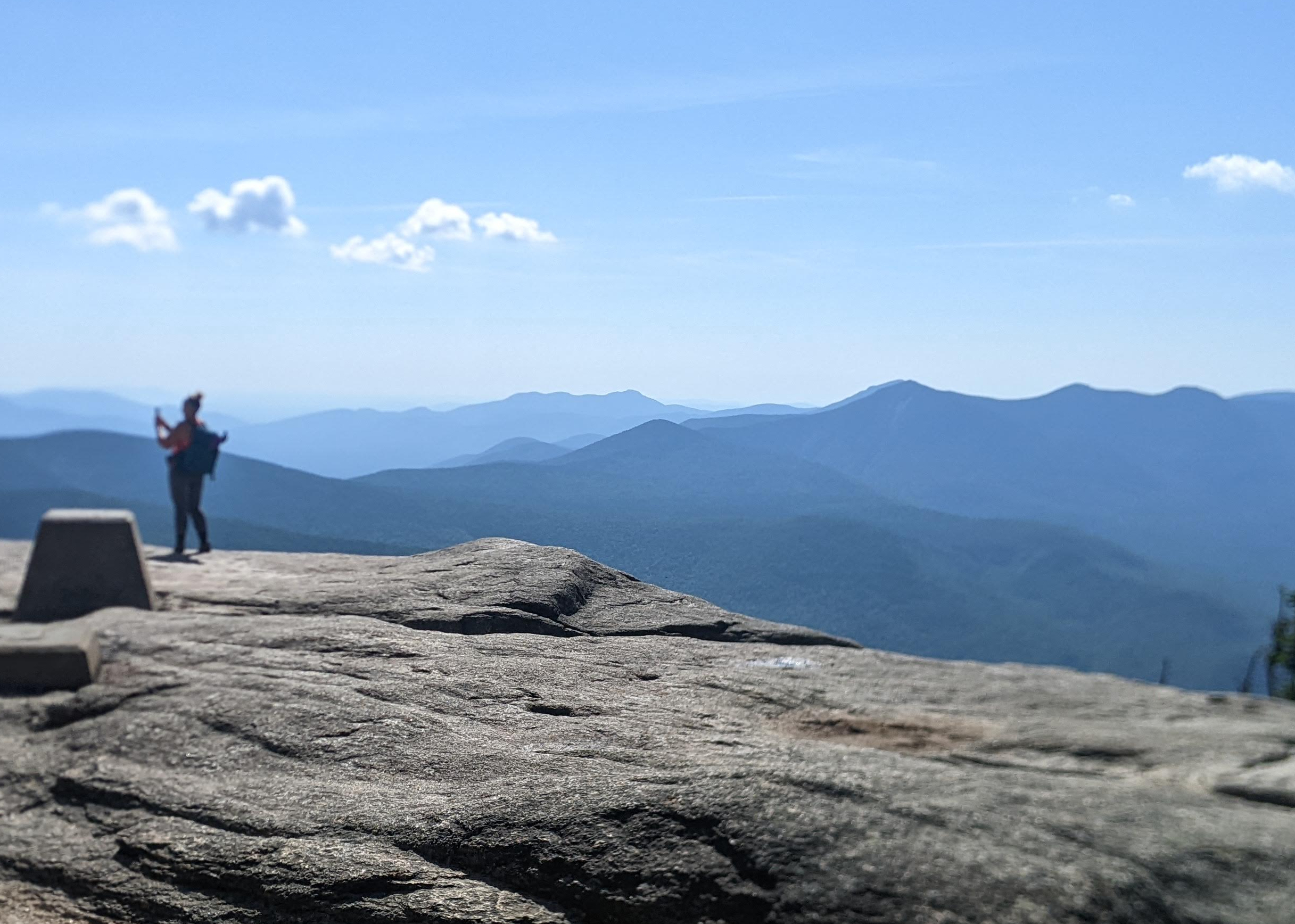 Broad granite ledge on the summit of Mt. Osceola with views of New Hampshire's White Mountains